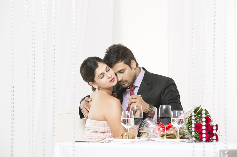 couple in romantic mood at dinner table 