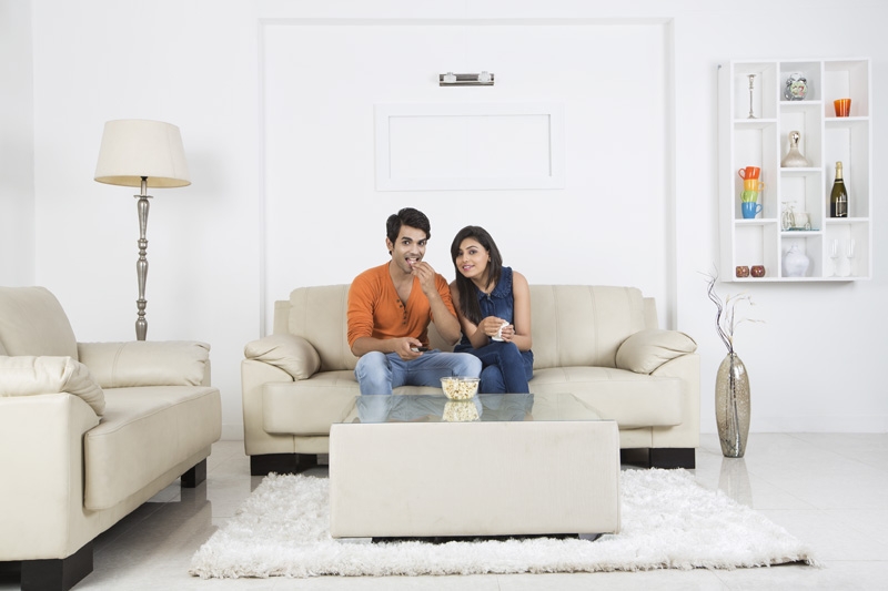 couple having popcorn and watching television