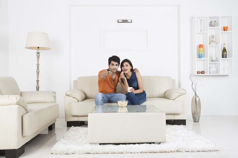 couple watching television with popcorn