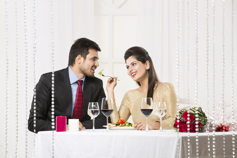 girl feeding man on romantic dinner date