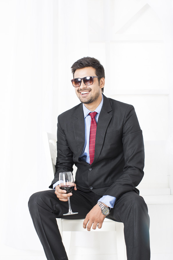 man in formals with a glass of wine 