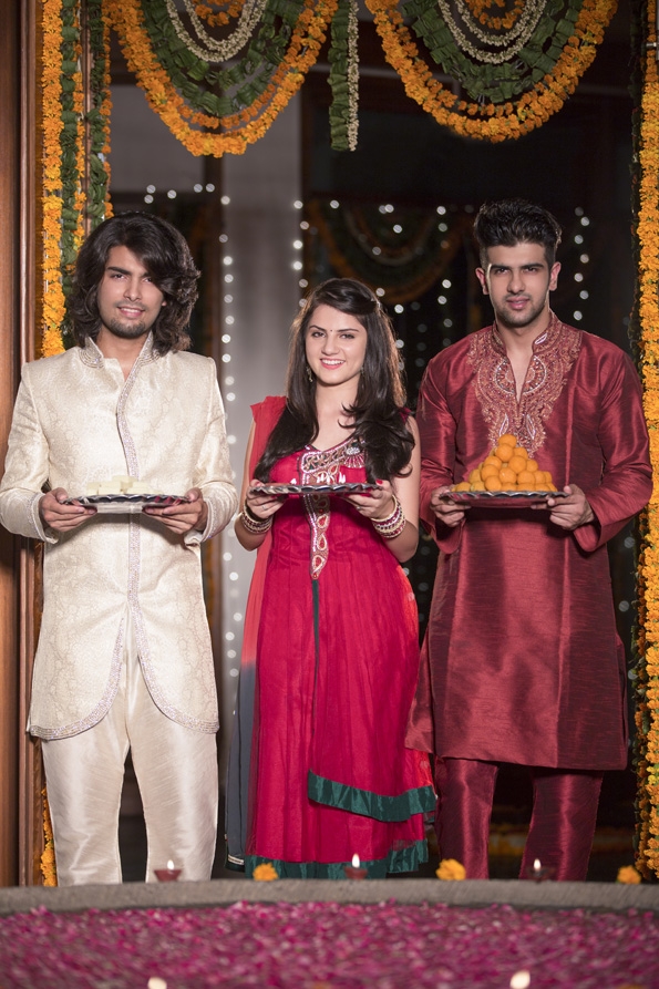 people in traditional wear standing with thali on diwali