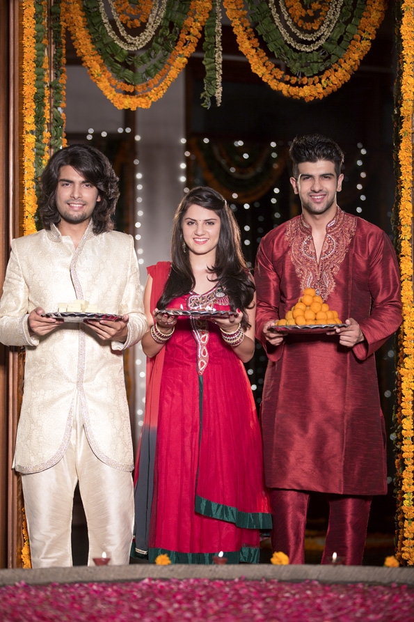 people in traditional wear standing with thali on diwali