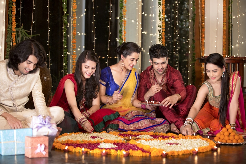 couples celebrating diwali and decorating home