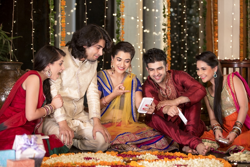 group of friends checking diwali pictures on mobile