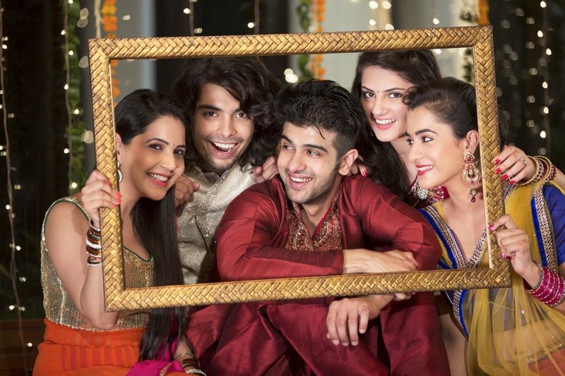 group of friends posing with frame on diwali 