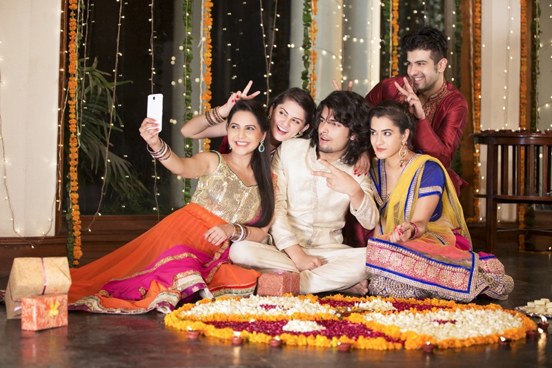 friends posing while taking selfie on diwali