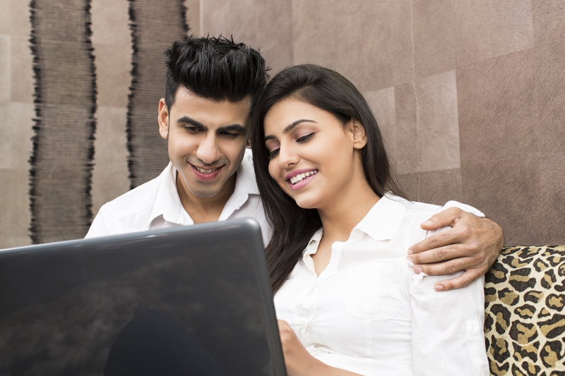 young couple browsing in laptop