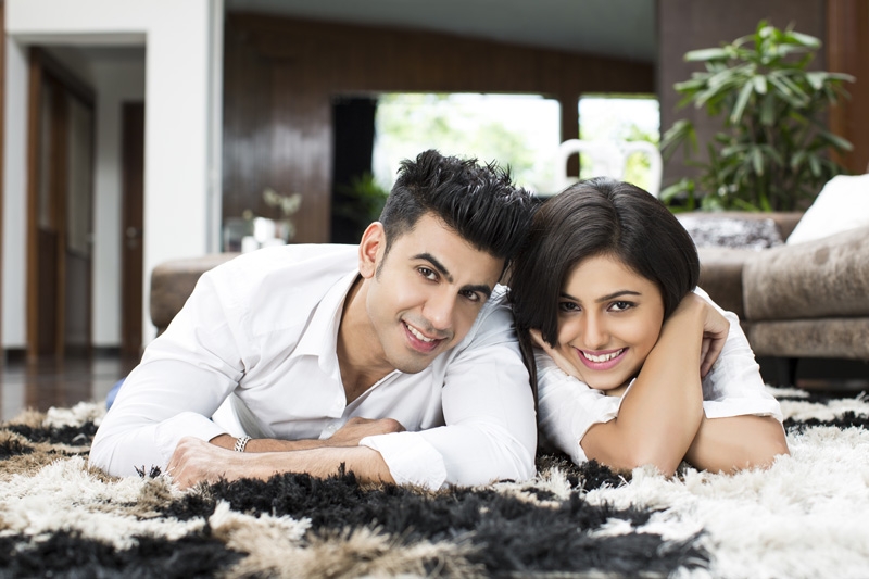 couple at home posing while looking at the camera 
