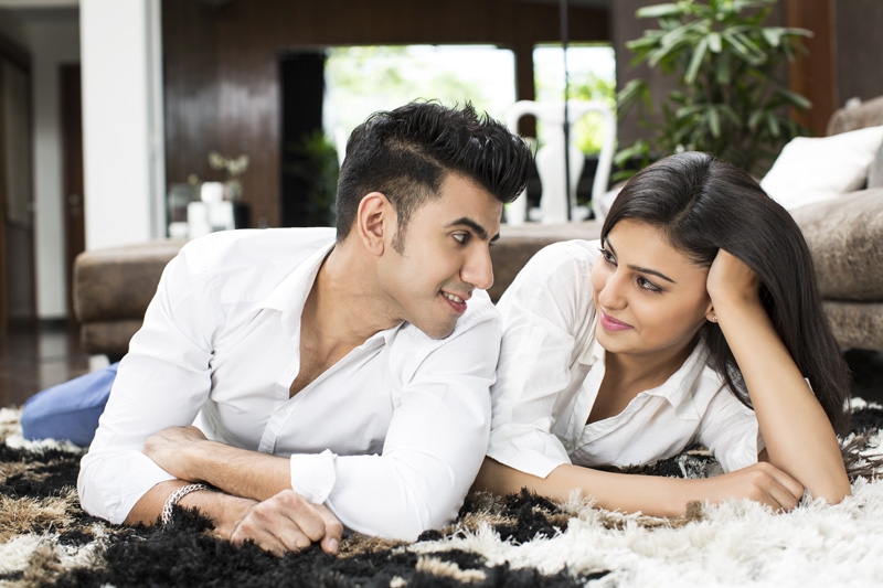 couple looking at each other while lying on floor