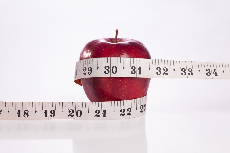 apple with white measuring tape
