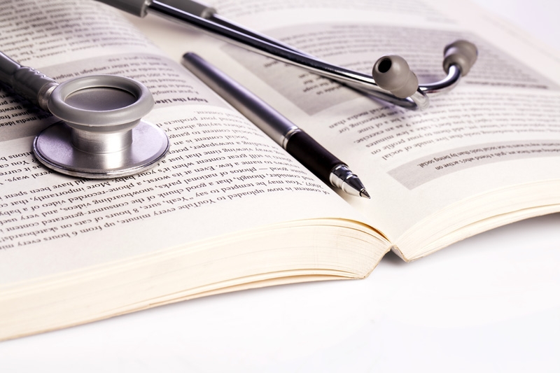 stethoscope and book isolated on white
