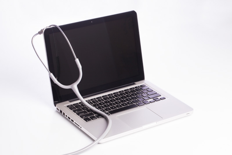 medical stethoscope on a modern laptop