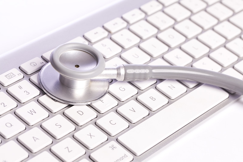 close-up of stethoscope on a white keyboard