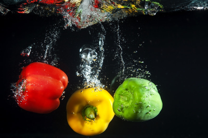 coloured capsicums in water