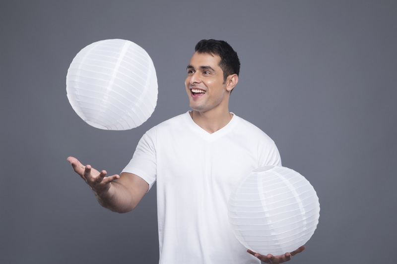 man juggling lamps 