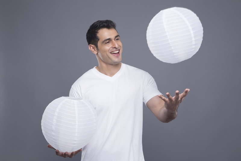 man playing with lamps 