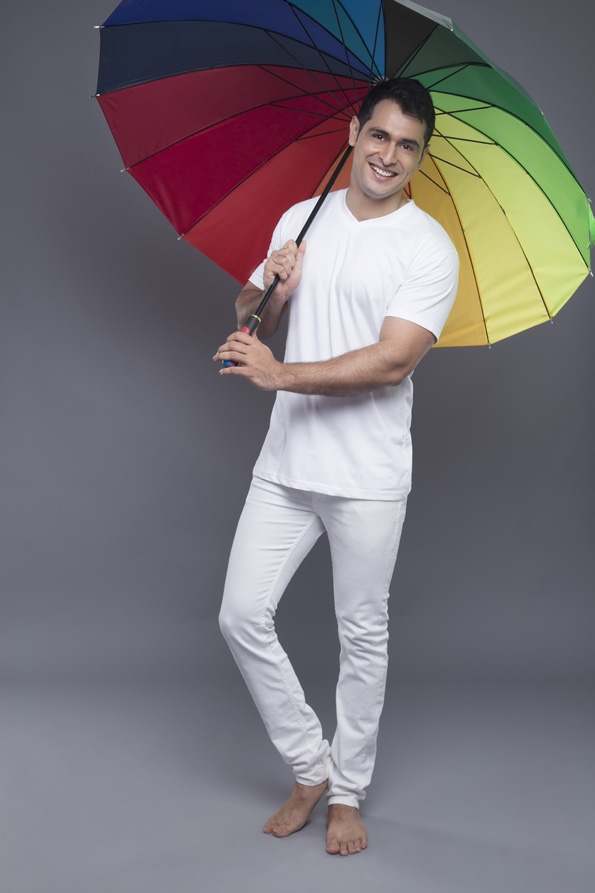 man posing with a colourful umbrella 