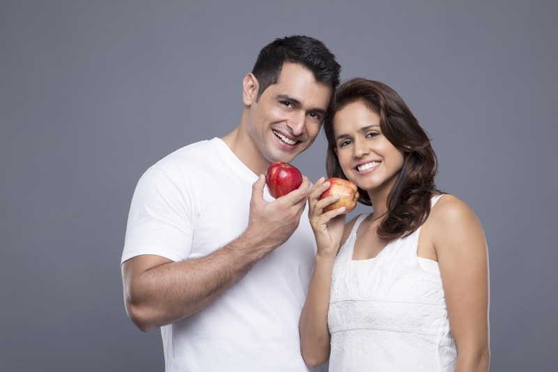 couple posing with apple