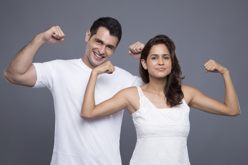 couple showing off their biceps