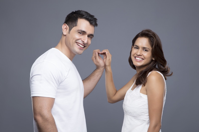 couple showing off love hand gesture