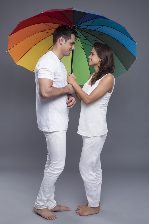 couple posing with an umbrella 