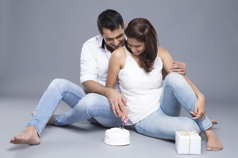 husband and wife cutting cake 