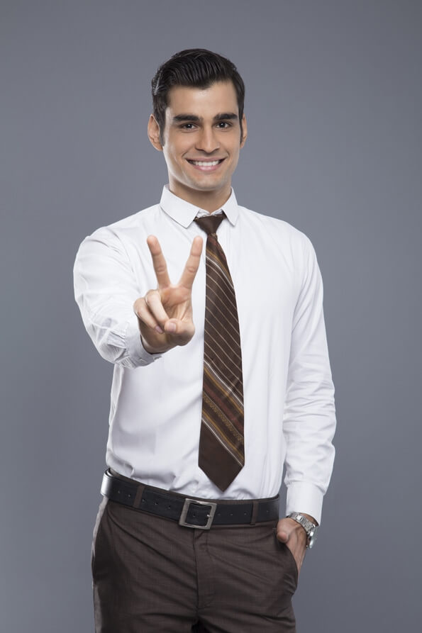 professionally dressed doing victory gesture