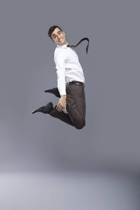 professionally dressed man jumping in air 