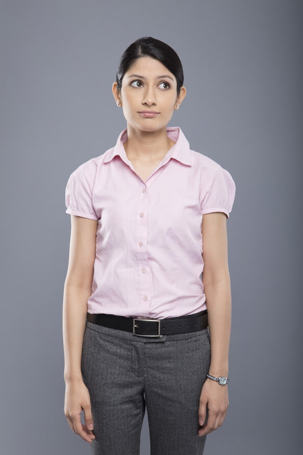 simple corporate girl standing with arms down over grey background