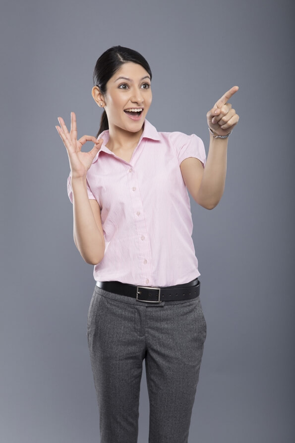 cheerful beautiful business woman pointing and looking at copyspace