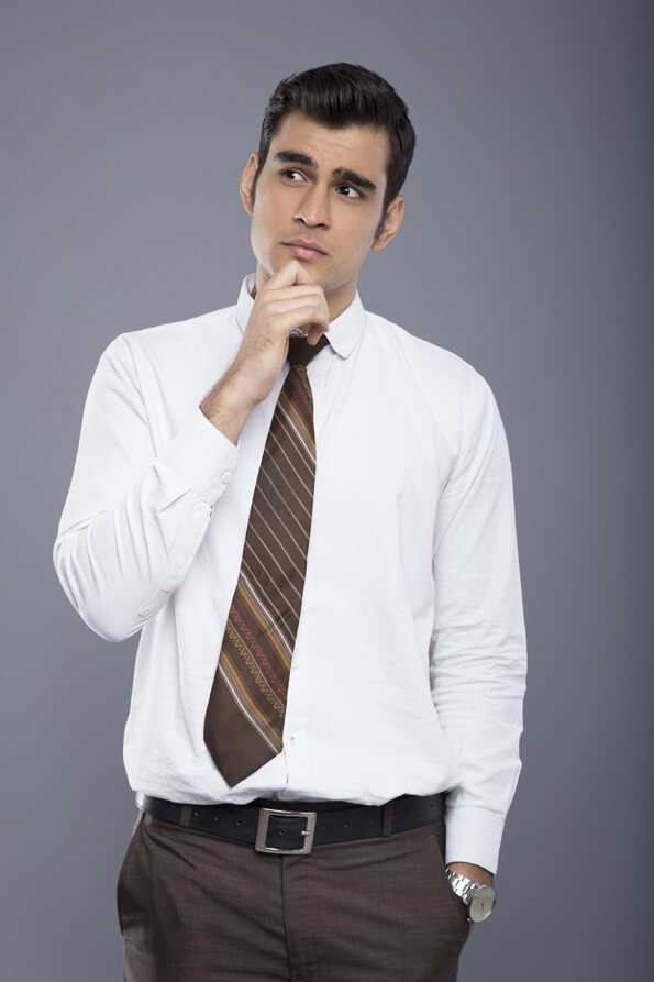 man thinking and posing in office attire