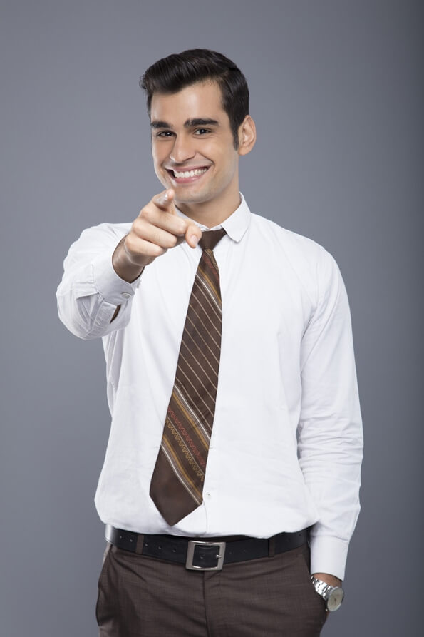 professionally dressed man pointing hands in the air 