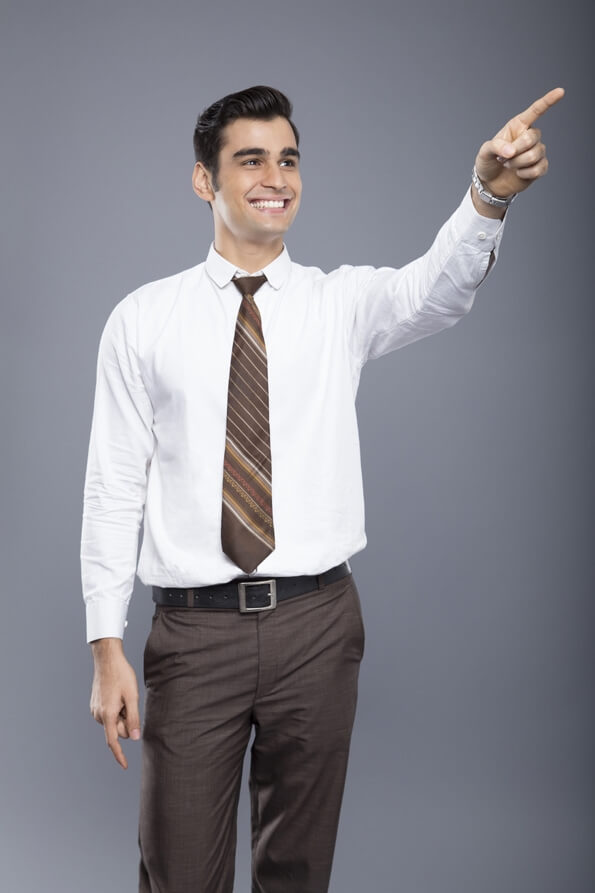 professionally dressed man pointing hands in the air 