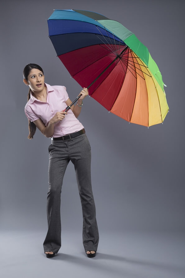 woman formally dressed standing with umbrella