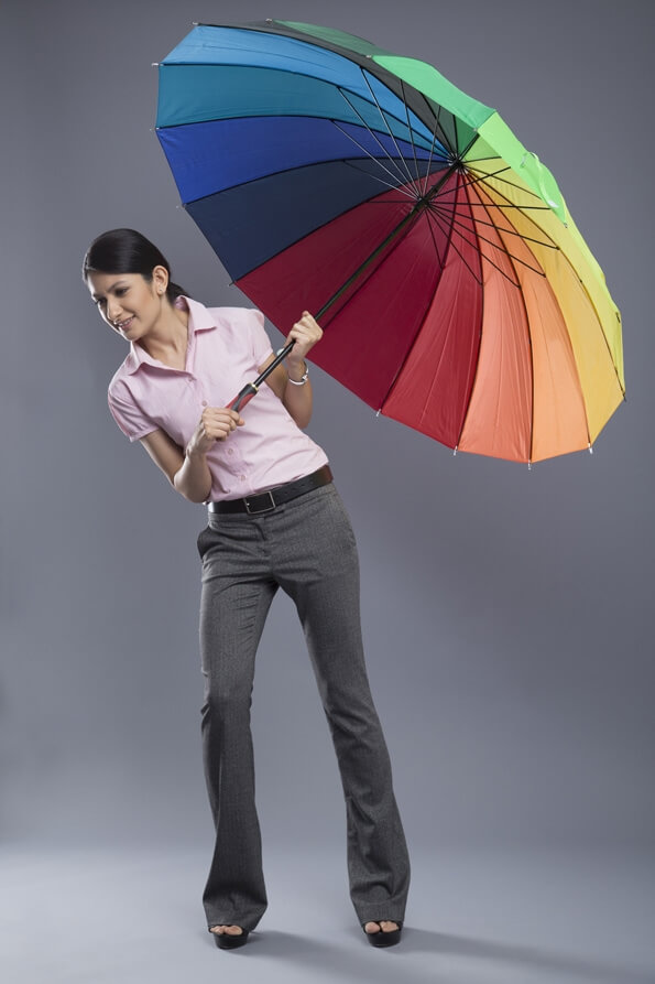 woman formally dressed standing with umbrella