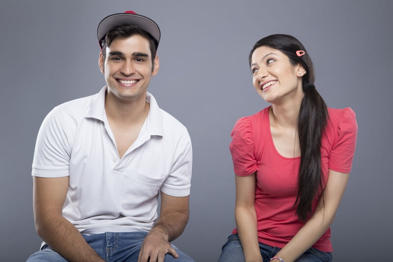 cheerful young couple isolated on grey