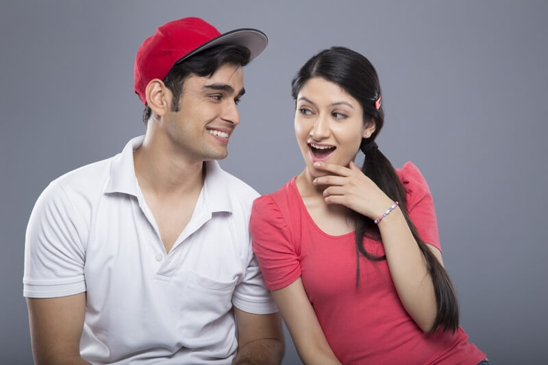 cheerful young couple isolated on grey