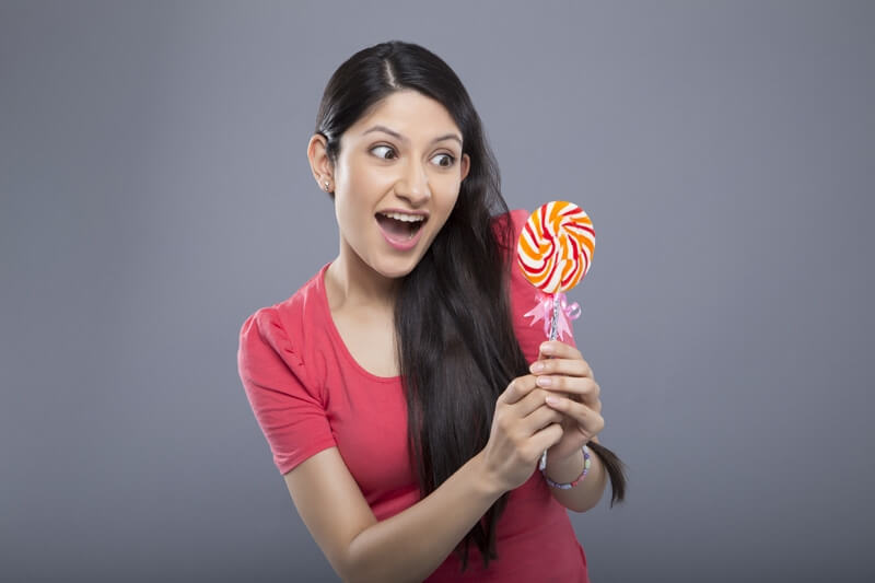 young female posing with a candy