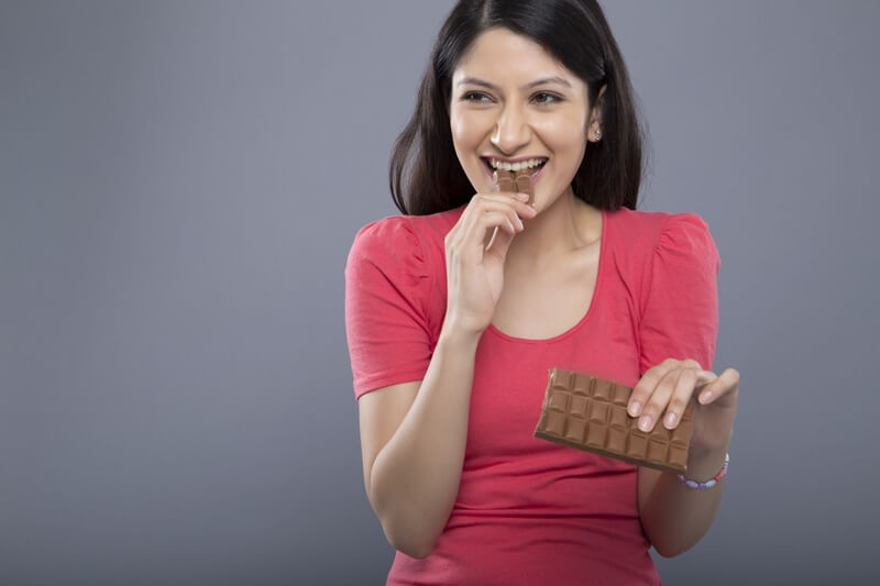 woman eating chocolate in a messy way