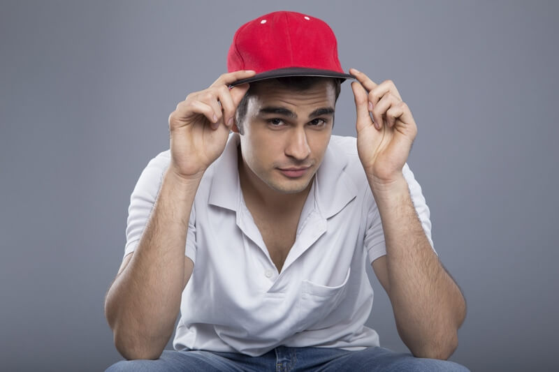man in casuals posing with cap