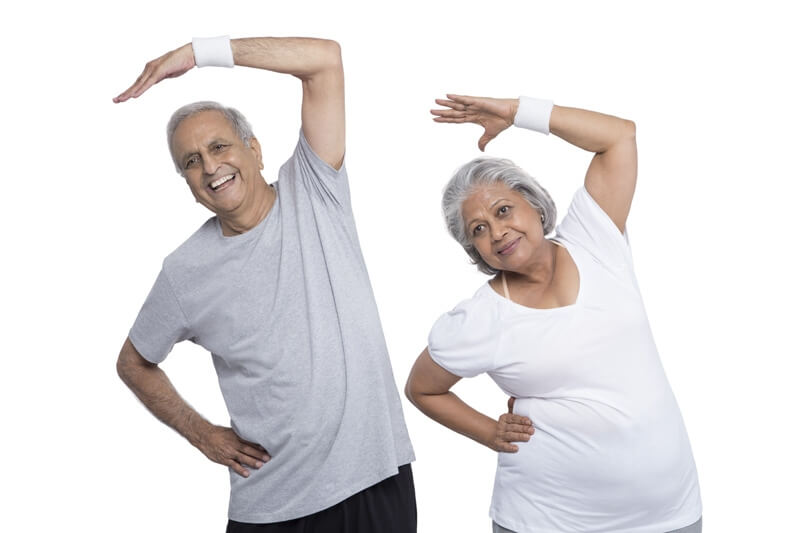 old couple exercising in gym wear