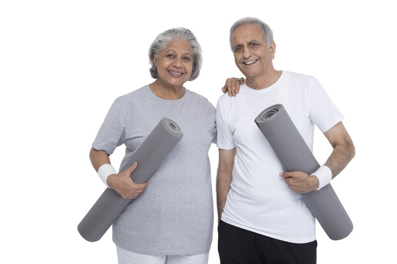old couple with yoga mat 