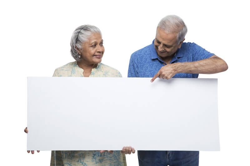 old couple with message board 