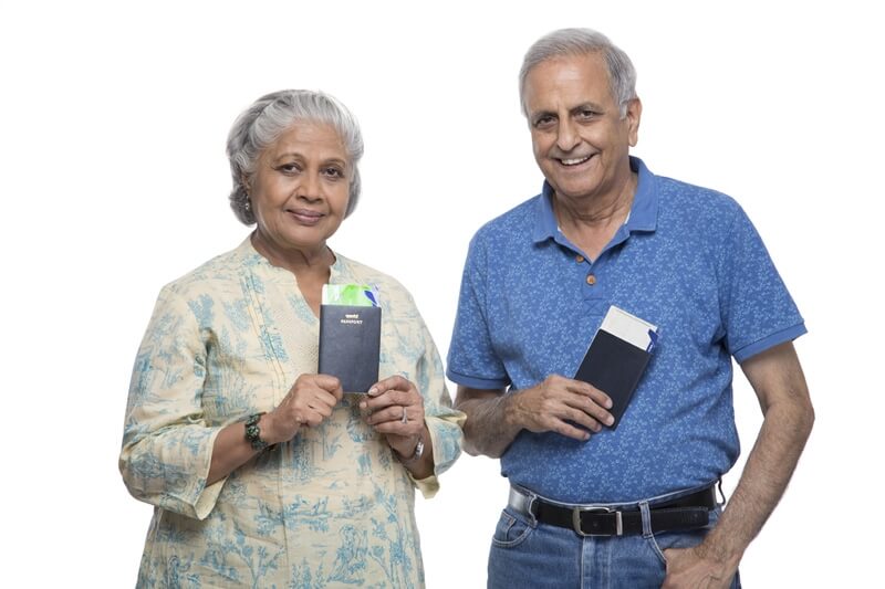 old couple at airport with passports 