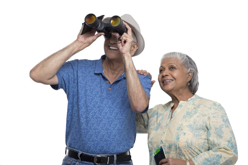 old couple looking through the binoculars 