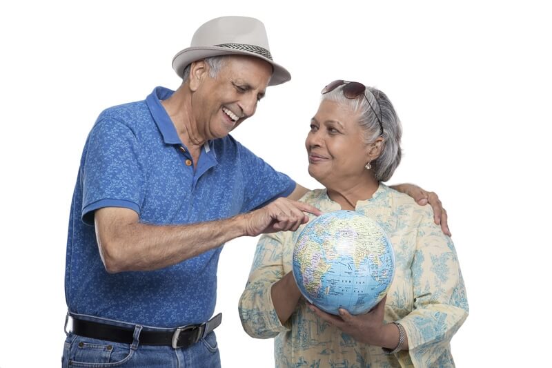 old couple holding a desktop globe
