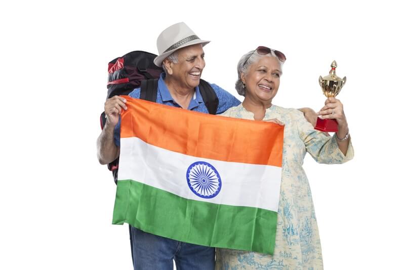 old couple with indian flag and trophy