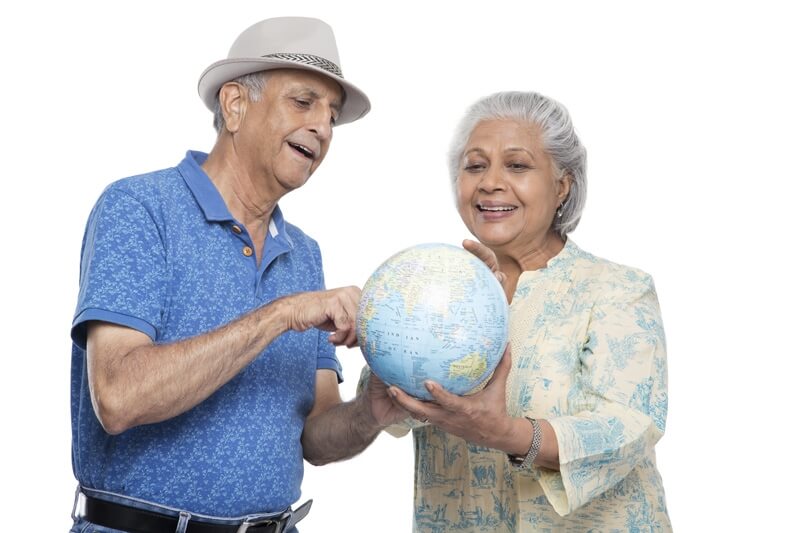 old couple holding a desktop globe