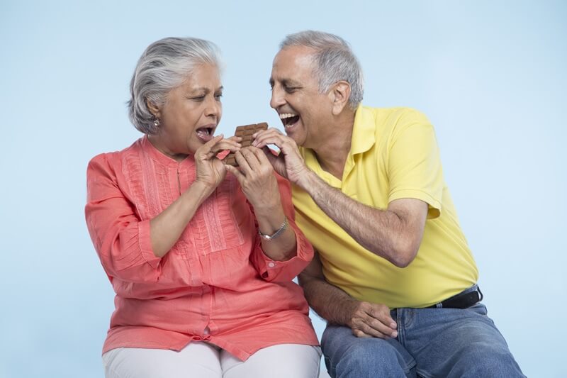 old couple eating chocolate 